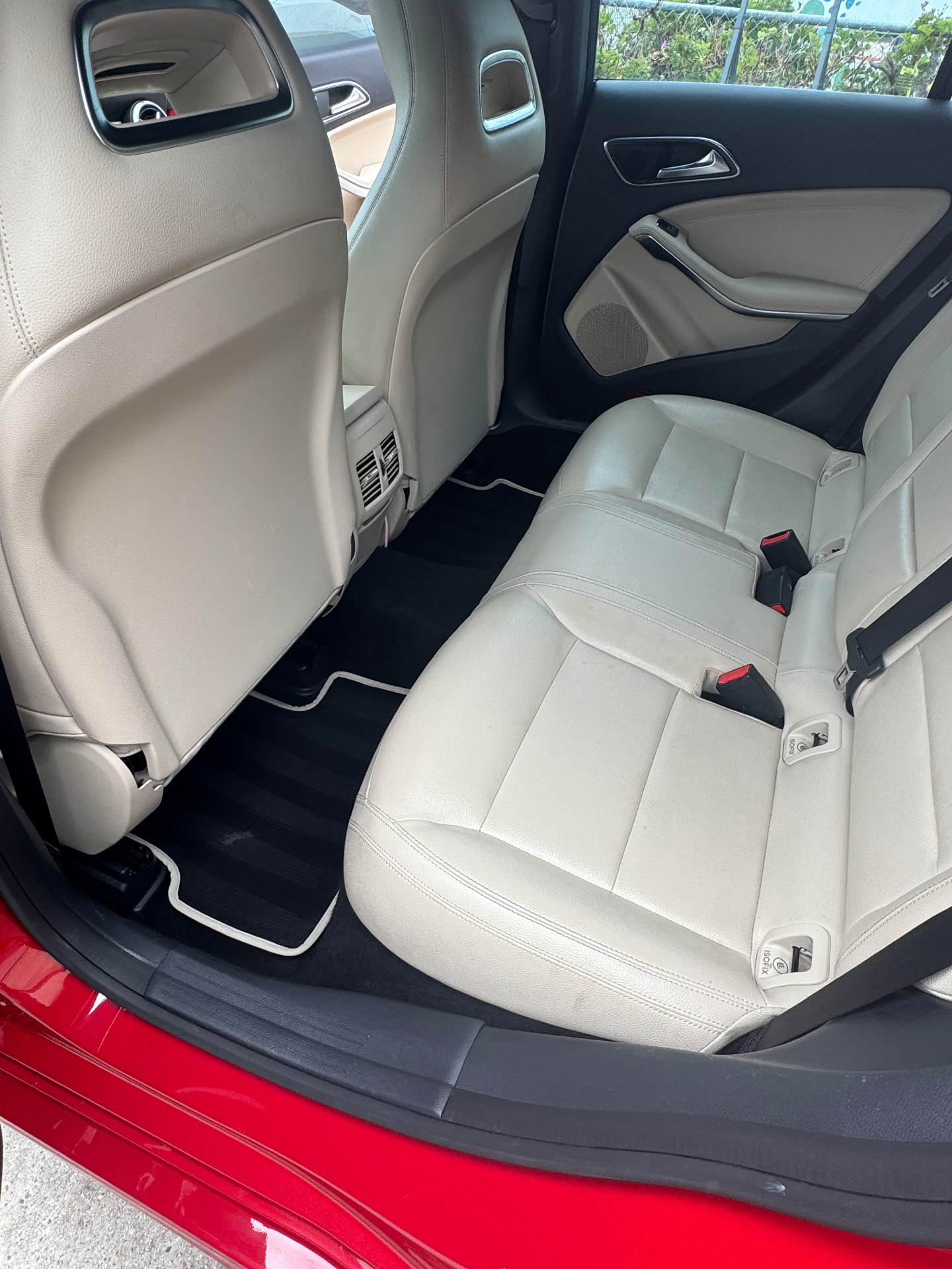 Freshly detailed light leather Mercedes rear seats and clean black floor mats